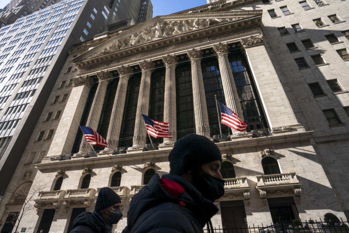 FILE - A pedestrian passes the New York Stock Exchange, Monday, Jan. 24, 2022, in New York. Stocks are falling and bond yields are snapping higher, Thursday, Feb. 10, 2022, after a hot reading on inflation led investors to anticipate a big increase in interest rates at the Federal Reserve's meeting next month.