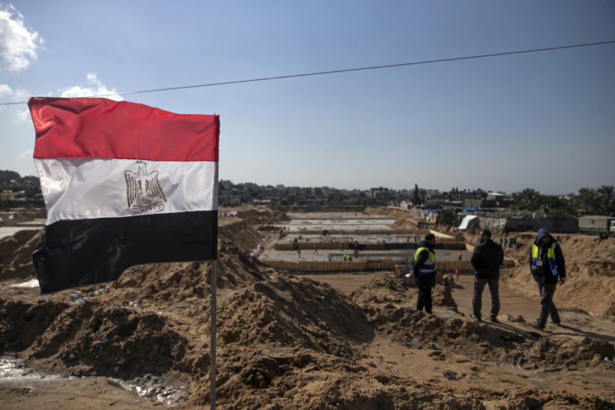 Laborers work on concrete slab foundations for one of three Egyptian-funded housing complexes in the Gaza Strip, in the town of Beit Lahiya, northern Gaza, Tuesday, Jan. 25, 2022. After years of working behind the scenes as a mediator, Egypt is taking on a much larger and more public role in Gaza. In the months since it brokered a Gaza cease-fire last May, Egypt has sent crews to clear rubbled and promised to build vast new apartment complexes, and billboards of its president Abdel-Fattah el-Sissi, are a common sight.