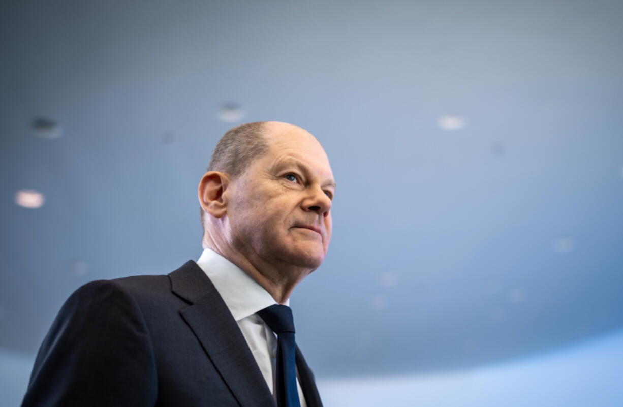 FILE - German Chancellor Olaf Scholz leaves after a news conference, ahead of a one-day closed meeting of the German Cabinet at the Chancellery in Berlin, Germany, Friday, Jan. 21, 2022.  Scholz is flying to Washington this week to reassure Americans that his country stands alongside the United States and other NATO partners in opposing any Russian aggression against Ukraine. Scholz has publicly said that Moscow would pay a "high price" in the event of an attack. But his government's refusal to supply lethal weapons to Ukraine, bolster its troop presence in eastern Europe or spell out which sanctions it would support against Russia has drawn criticism abroad and at home.