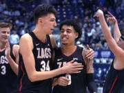 Gonzaga center Chet Holmgren (34) andguard Julian Strawther (0) walk off the court following the team's win in an NCAA college basketball game against BYU on Saturday, Feb. 5, 2022, in Provo, Utah.