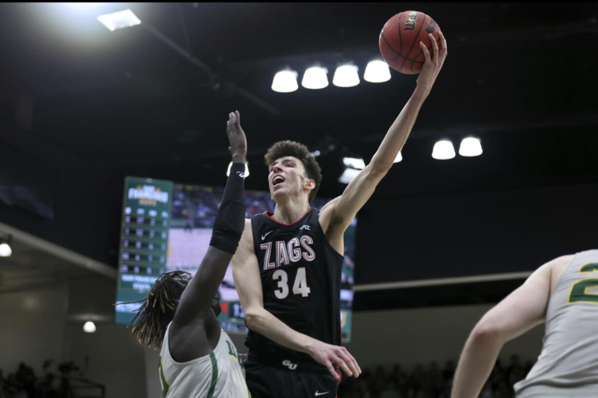 Gonzaga center Chet Holmgren (34) shoots against San Francisco forward Josh Kunen, left, during the second half of an NCAA college basketball game in San Francisco, Calif., Thursday, Feb. 24, 2022.