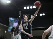 Gonzaga center Chet Holmgren (34) shoots against San Francisco forward Josh Kunen, left, during the second half of an NCAA college basketball game in San Francisco, Calif., Thursday, Feb. 24, 2022.