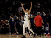 Recently acquired Pelicans' guard CJ McCollum (3) acknowledges the fans as he steps onto the court for the first time in New Orleans prior to tip off against the Miami Heat on Thursday.