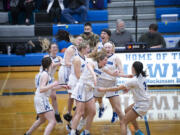 The Hockinson girls basketball players celebrate after their 58-53 win over Washougal on Wednesday, Feb.