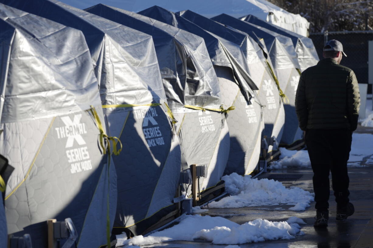 Tents stand in a long row at the east safe outdoor space in the parking lot of the city of Denver Human Service building in Denver on Thursday, Feb. 17, 2022. The safe space is home to more than 150 people.