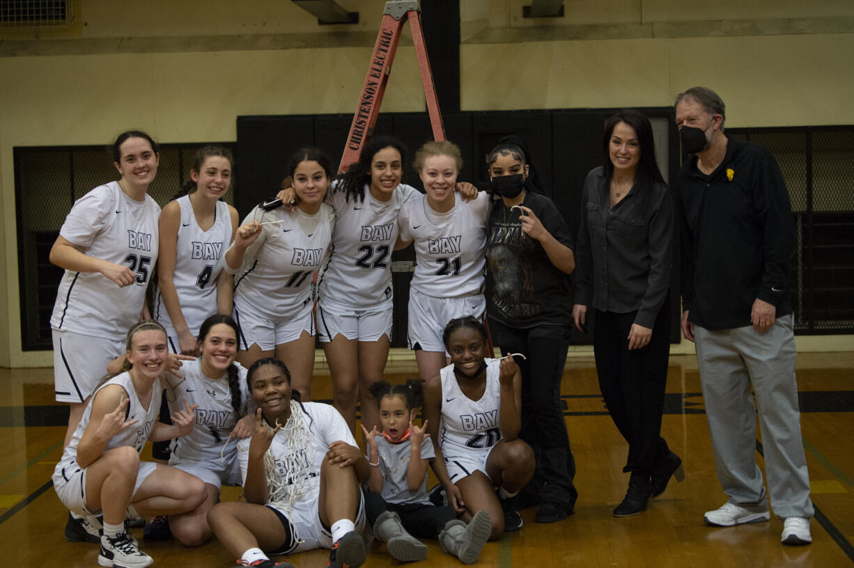 The Hudson's Bay girls basketball team poses for a team photo after Hudson's Bay beat Woodland 60-18 to clinch the 2A Greater St. Helens League girls bassketball title on Thursday, Feb. 3, 2022.