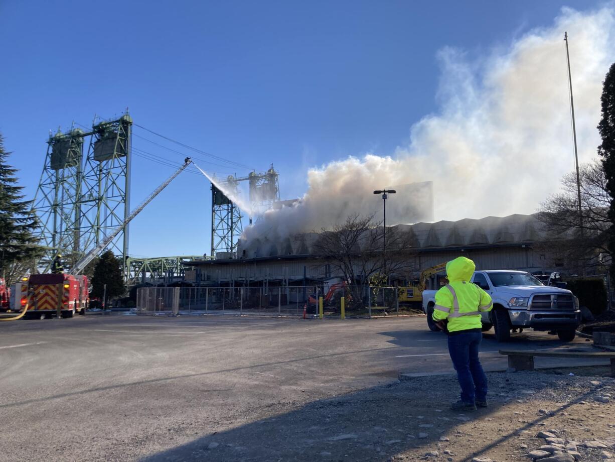 A roof fire burns in the former Red Lion at the Quay on Tuesday afternoon. The building was undergoing demolition work when the three-alarm fire began.