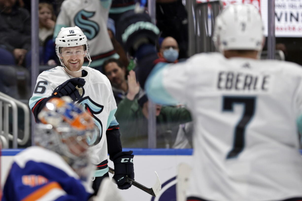 Seattle Kraken left wing Jared McCann (16) gestures towards Jordan Eberle (7) after scoring a goal past New York Islanders goaltender Semyon Varlamov in the third period of an NHL hockey game Wednesday, Feb. 2, 2022, in Elmont, N.Y. The Kraken won 3-0.