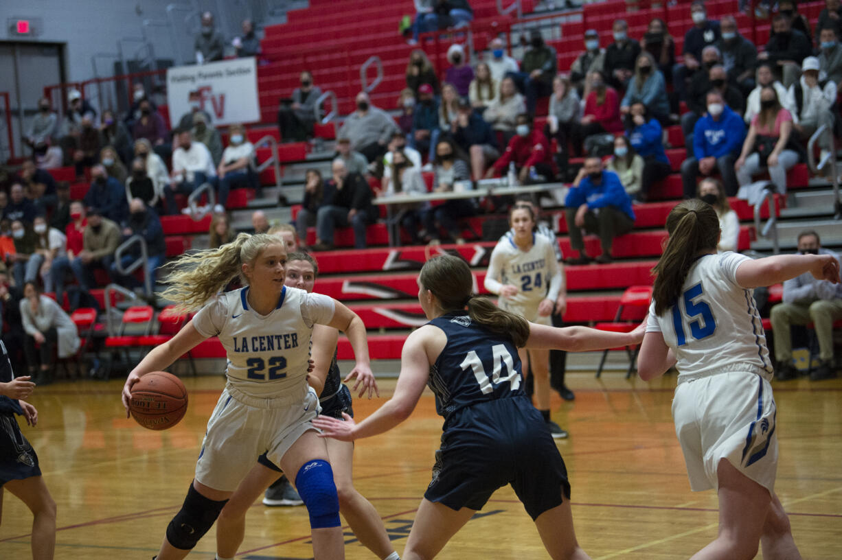 La Center’s Alyse Webberley (22) dribbles against King’s Wasy Christian’s Laurel Quinn (14) during the Wildcats’ 57-38 win over the Knights in a district winner-to-state girls basketball game at Fort Vancouver.