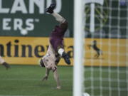 Portland Timbers midfielder Dairon Asprilla (27) does a cartwheel while celebrating after scoring a goal against the New England Revolution during the second half of an MLS soccer match, Saturday, Feb. 26, 2022, in Portland, Ore.