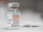 A vial of the Moderna COVID-19 vaccine is displayed on a counter at a pharmacy in Portland, Ore., Monday, Dec. 27, 2021. U.S. regulators have granted full approval to Moderna's COVID-19 vaccine after reviewing additional data on its safety and effectiveness. The decision Monday, Jan. 31, 2022 by the Food and Drug Administration comes after many tens of millions of Americans have already received the shot under its original emergency authorization. Full approval means FDA has completed the same rigorous, time-consuming review for Moderna's shot as dozens of other long-established vaccines.