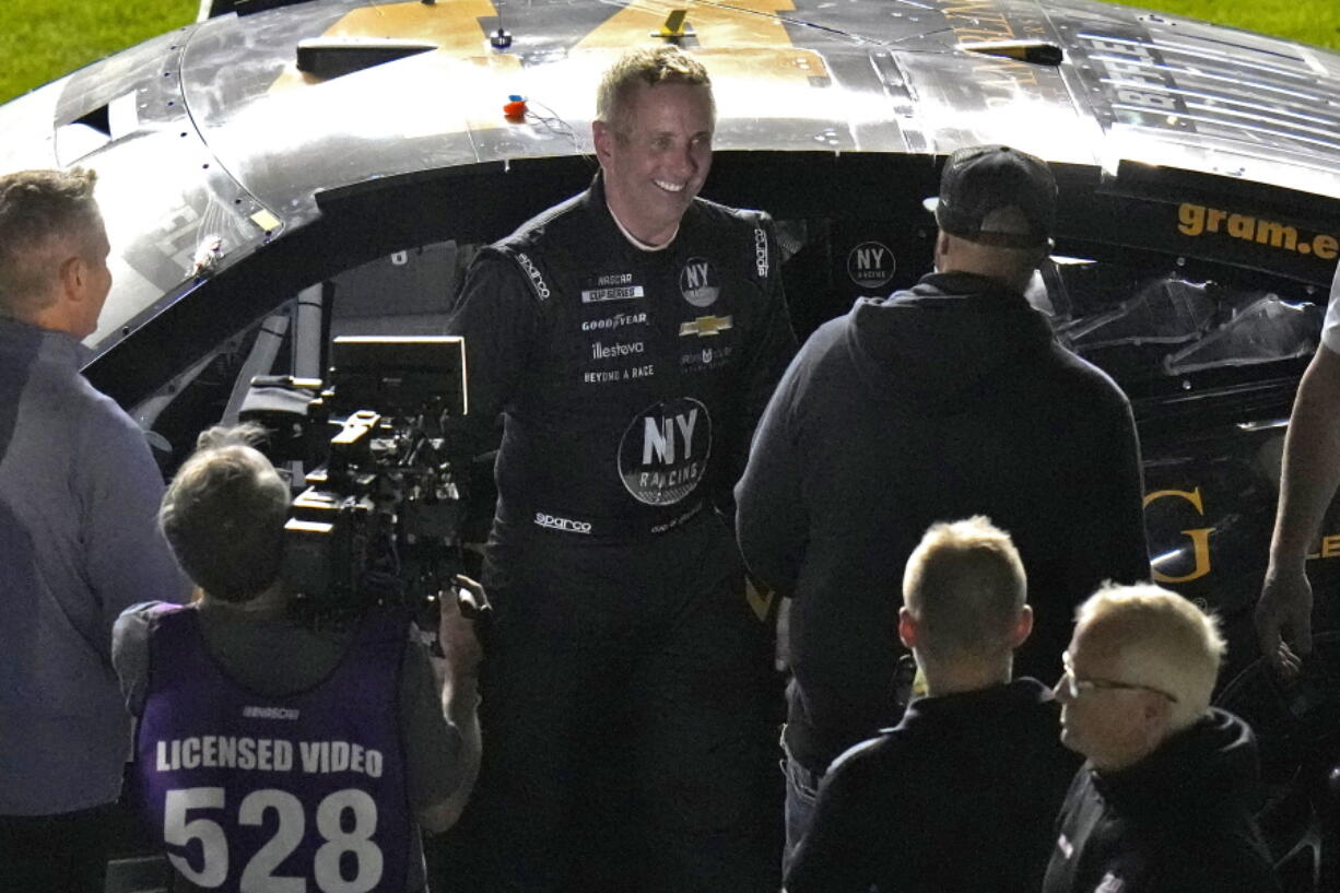 Greg Biffle, center, smiles after finishing during the second of two NASCAR Daytona 500 qualifying auto races Thursday, Feb. 17, 2022, at Daytona International Speedway in Daytona Beach, Fla. Biffle was able to make it into Sunday's race.