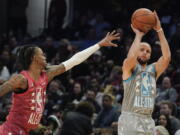 Golden State Warriors' Stephen Curry, right, shoots for three as Memphis Grizzlies' Ja Morant defends during the second half of the NBA All-Star basketball game, Sunday, Feb. 20, 2022, in Cleveland.