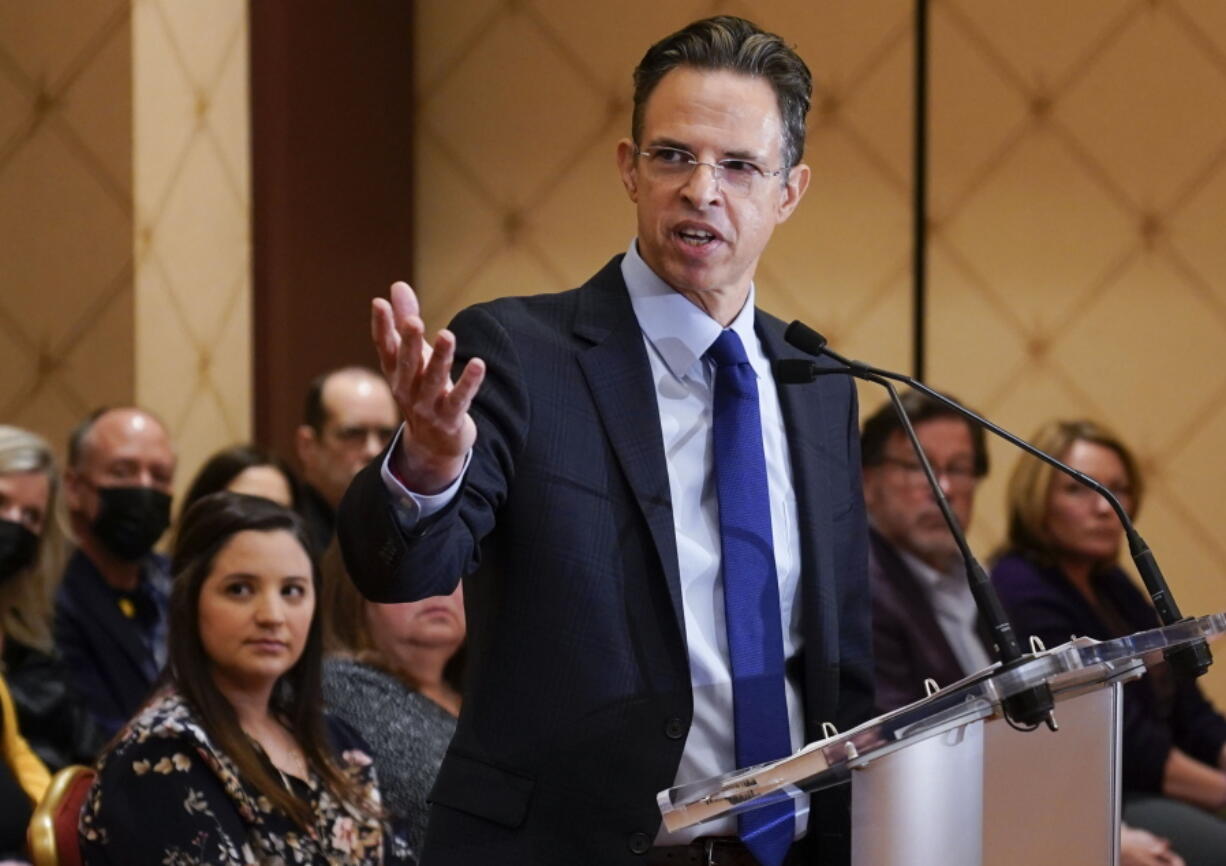 FILE - While families of the victims of the Sandy Hook Elementary School shooting look on, attorney Josh Koskoff speaks during a news conference in Trumbull, Conn., Tuesday, Feb. 15, 2022. After agreeing to a $73 million lawsuit settlement with gun-maker Remington, the families of nine Sandy Hook Elementary School shooting victims say they are shifting their focus to ending firearms advertising.