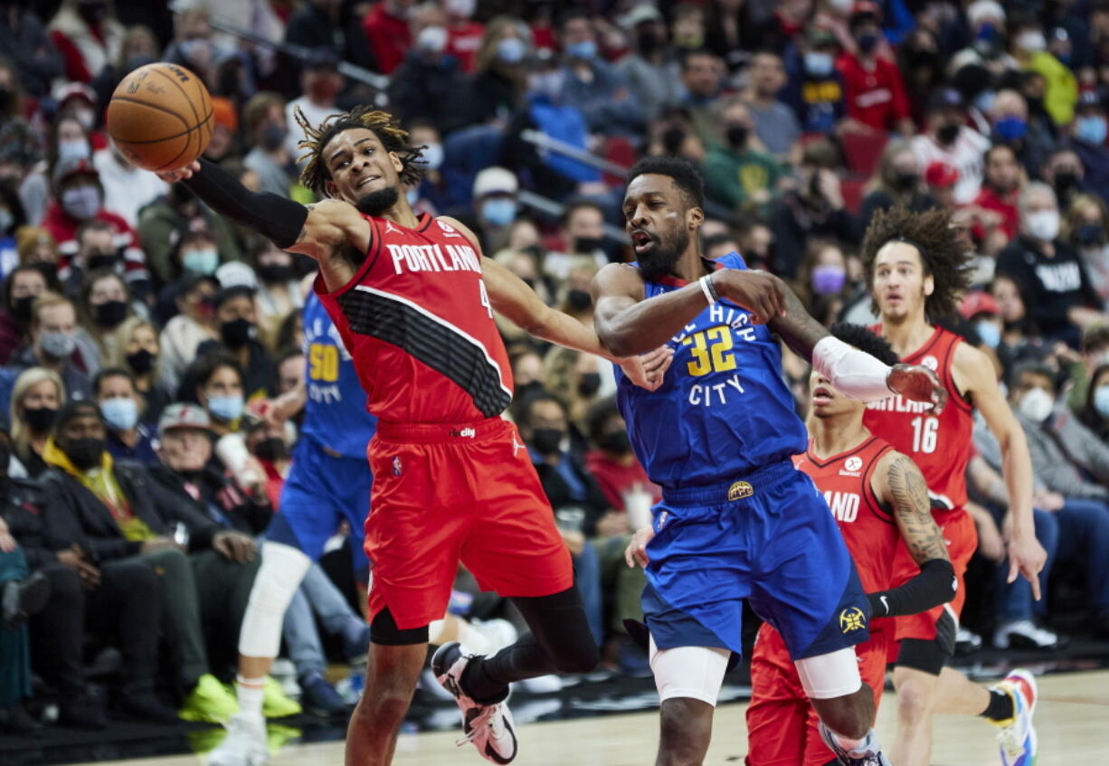 Portland Trail Blazers forward Greg Brown III, left, reaches for the ball in front of Denver Nuggets forward Jeff Green on Sunday in Portland.