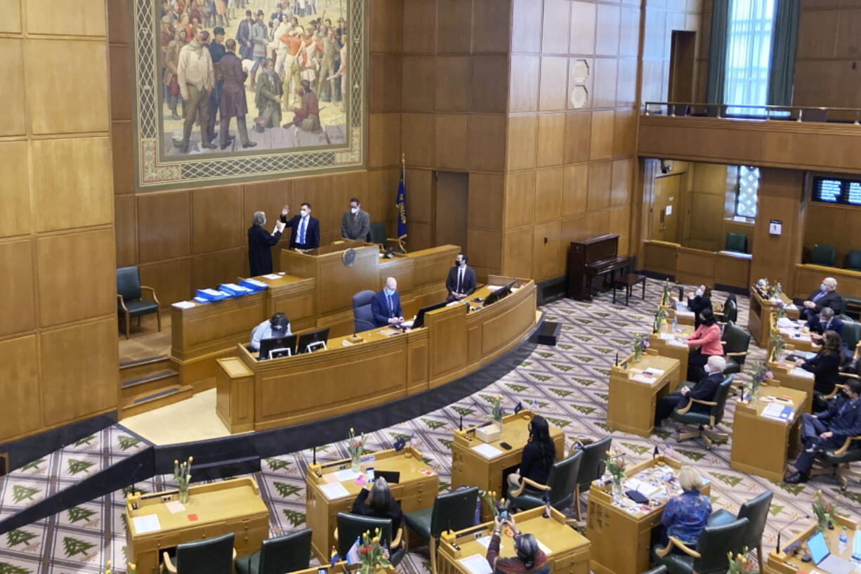 Oregon Chief Justice Martha Walters swears in new House Speaker Dan Rayfield on Tuesday, Feb. 1, 2022, in Salem, Ore., minutes after the Democrat was elected by House lawmakers to replace former Speaker Tina Kotek, who has stepped down to run for governor. Tuesday was the opening day of the 2022 legislative session. Priorities include affordable housing, bolstering the state's workforce and reserving a $500 million cushion for the next biennium.