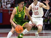 Utah guard Lazar Stefanovic (20) defends against Oregon guard Will Richardson (0) during the first half of an NCAA college basketball game Saturday, Feb. 5, 2022, in Salt Lake City.