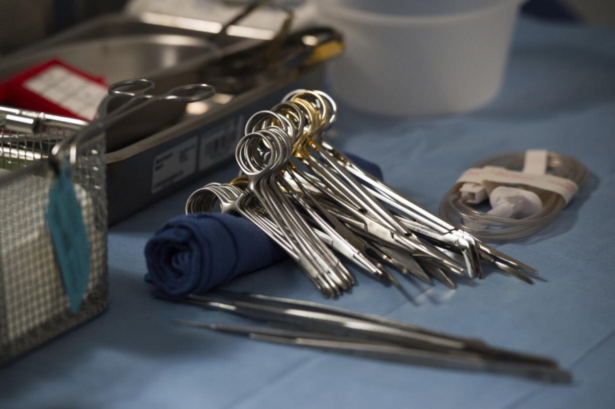 FILE - Surgical instruments and supplies lay on table during a kidney transplant surgery at MedStar Georgetown University Hospital in Washington D.C., Tuesday, June 28, 2016. The U.S. transplant system isn't fair enough and needs an overhaul to stop wasting organs and give more patients an equal chance at the life-saving surgery, says an influential scientific advisory panel.