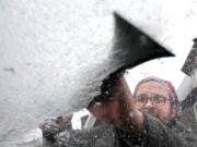 Jason Fried scraps ice off the windshield of his minivan, on Friday, Feb. 25, 2022, in Erie, Pa. "I'm over it," said Fried, 42, of the latest batch of winter weather in the Erie region.