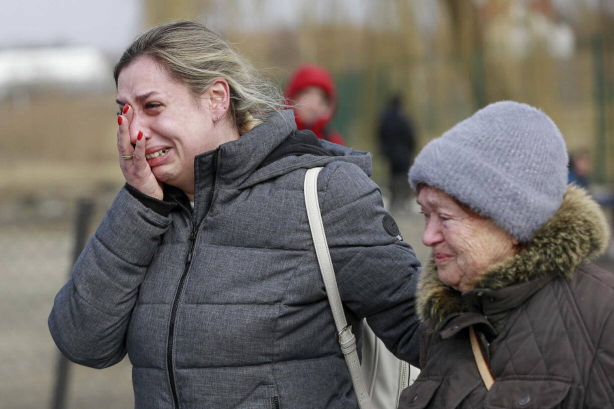 A Ukrainian woman reacts after arriving at the Medyka border crossing, in Poland, Sunday, Feb. 27, 2022. Since Russia launched its offensive on Ukraine, more than 200,000 people have been forced to flee the country to bordering nations like Romania, Poland, Hungary, Moldova, and the Czech Republic -- in what the U.N. refugee agency, UNHCR, said will have "devastating humanitarian consequences" on civilians.