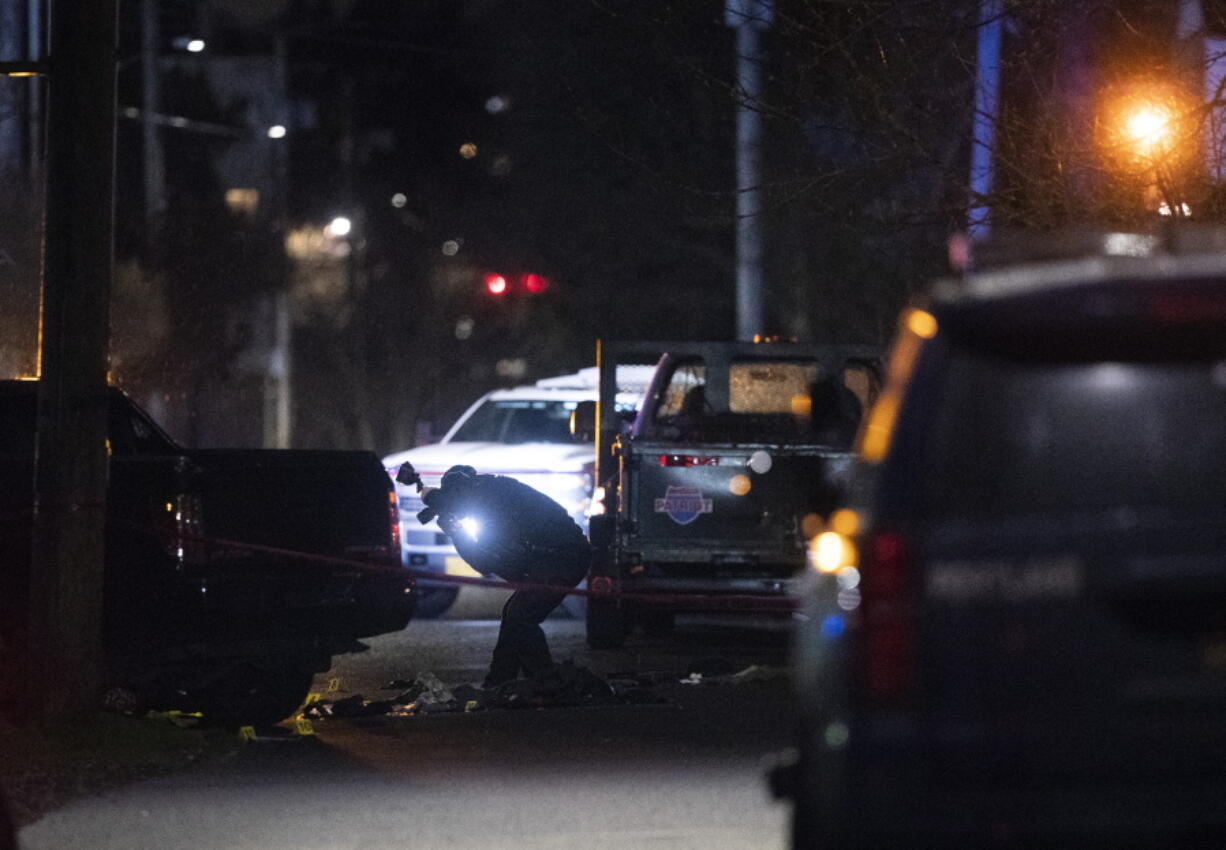 Portland police respond, on Saturday, Feb. 19, 2022, to a shooting in the area of Normandale Park in Northeast Portland, Ore. One person was killed and five others were wounded in a shooting at the Portland park where a march was planned to protest police violence.