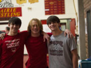 The Blick brothers -- (from left to rigth) senior Josh, sophomore Seth and senior Caleb -- posed for a photo in Prairie High School's wrestling room after all three brothers qualified for the 2A state tournament.