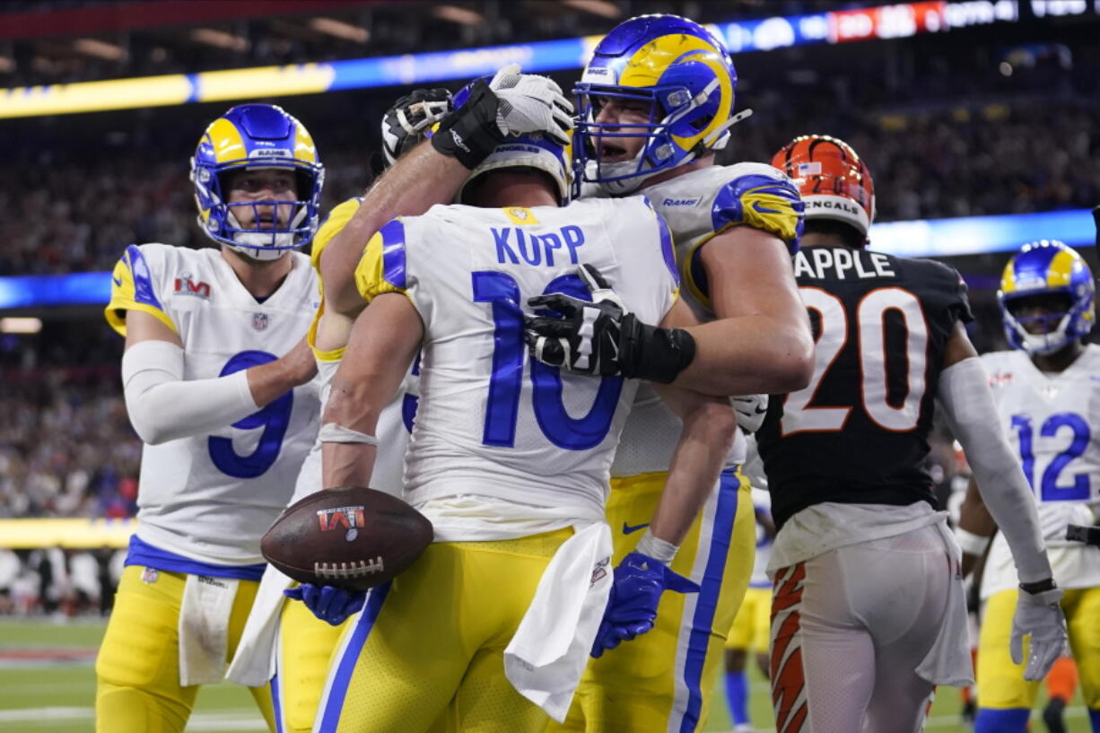 Los Angeles Rams wide receiver Cooper Kupp (10) is congratulated by teammates after scoring a touchdown against the Cincinnati Bengals during the second half of the NFL Super Bowl 56 football game Sunday, Feb. 13, 2022, in Inglewood, Calif.