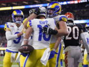 Los Angeles Rams wide receiver Cooper Kupp (10) is congratulated by teammates after scoring a touchdown against the Cincinnati Bengals during the second half of the NFL Super Bowl 56 football game Sunday, Feb. 13, 2022, in Inglewood, Calif.