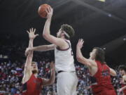 Gonzaga forward Drew Timme, center, shoots between Saint Mary's forward Matthias Tass, left, and guard Alex Ducas during the first half of an NCAA college basketball game Saturday, Feb. 12, 2022, in Spokane, Wash.