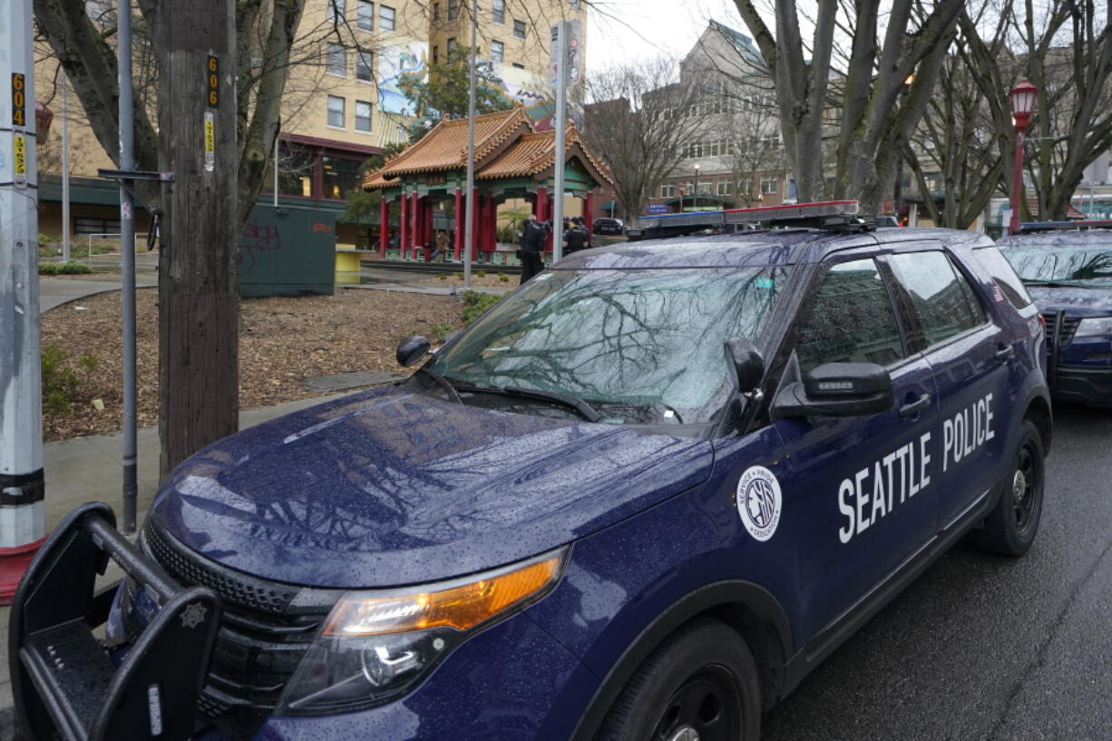 A Seattle police vehicle sits parked at Hing Hay Park on March 18, 2021, in Seattle. Seattle's elected prosecutor is promising quicker charging decisions to help tackle persistent low-level crime that's plagued businesses downtown. (Ted S.