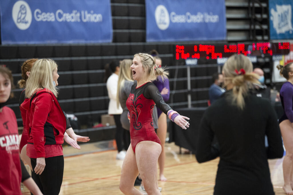 Camas senior Peyton Cody reacts with her coach Carol Willson after her routine on the bars, on which she placed third, at the 4A state gymnastics meet at Sammamish High School in Bellevue on Saturday, Feb. 26, 2022.