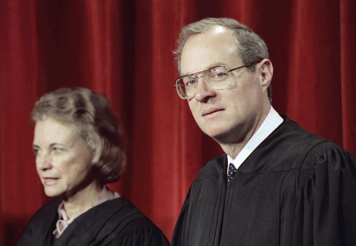 FILE - Justice Anthony Kennedy, the newest member of the Supreme Court, and Justice Sandra Day O'Connor, are shown on April 15, 1988, in Washington, at the Supreme Court during a picture taking session. The full court was also present for the photo session. For years, the Supreme Court moved to the left or right only as far as Justices O'Connor and Kennedy allowed. They held pivotal votes on a court closely divided between liberals and conservatives.