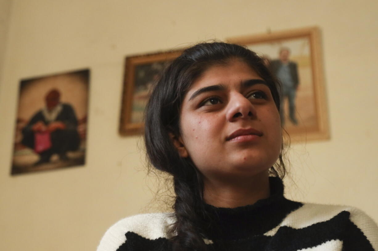 Roza Barakat poses for a portrait in a safe house in Hassakeh, Syria, Sunday, Feb. 6, 2022. Barakat was 11 years old when she was taken by IS militants, along with thousands of others, when the extremists overran her hometown of Sinjar in northwestern Iraq. Eight years later, she is living in the shadows, afraid to go home and fearing her community won't accept her.