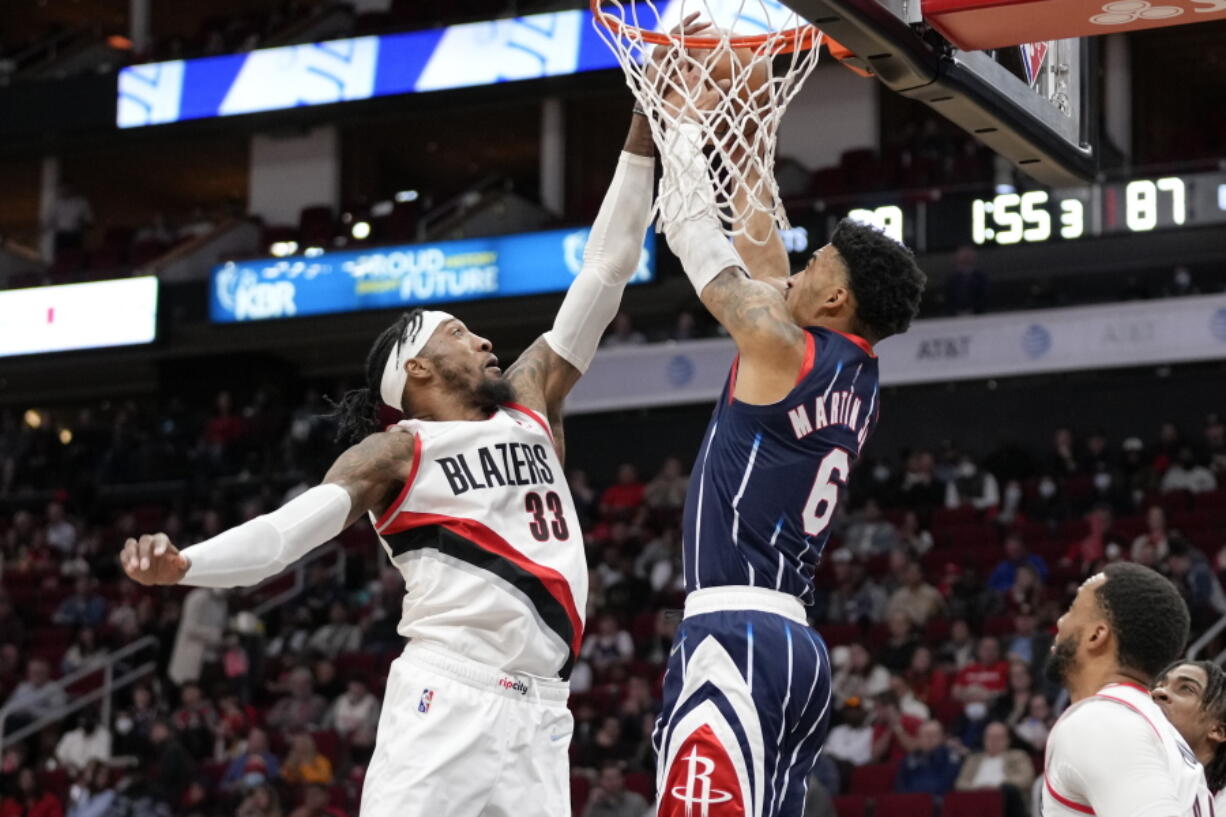 Portland Trail Blazers forward Robert Covington (33) blocks a shot by Houston Rockets forward Kenyon Martin Jr. (6) during the second half of an NBA basketball game, Friday, Jan. 28, 2022, in Houston.