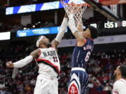 Portland Trail Blazers forward Robert Covington (33) blocks a shot by Houston Rockets forward Kenyon Martin Jr. (6) during the second half of an NBA basketball game, Friday, Jan. 28, 2022, in Houston.