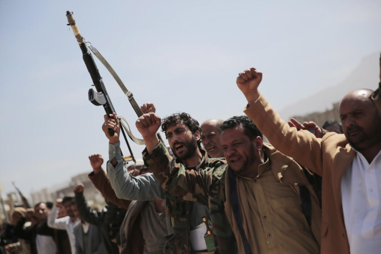 FILE - Armed Houthi fighters attend the funeral procession of Houthi rebel fighters who were killed in recent fighting with forces of Yemen's internationally recognized government, in Sanaa, Yemen, on Nov. 24, 2021. A clan-based militia government in the Arab world's poorest country is presenting the Biden administration with its latest foreign policy frustrations. Yemen's Houthis have launched three cross-border strikes with drones and ballistic missiles into the United Arab Emirates in as many weeks.