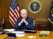 This image provided by The White House via Twitter shows President Joe Biden at Camp David, Md., Saturday, Feb. 12, 2022. Biden on Saturday again called on President Vladimir Putin to pull back more than 100,000 Russian troops massed near Ukraine's borders and warned that the U.S. and its allies would "respond decisively and impose swift and severe costs" if Russia invades, according to the White House.