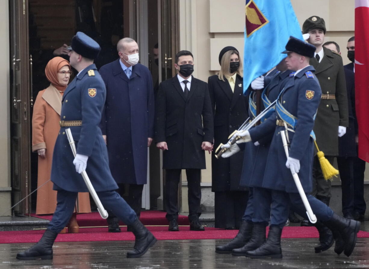 Ukrainian President Volodymyr Zelenskyy, centre, his wife Olena, centre right, Turkey's President Recep Tayyip Erdogan, centre left, accompanied by his wife Emine, left, review the honour guard during a welcome ceremony ahead of their meeting in Kyiv, Ukraine, Thursday, Feb. 3, 2022.