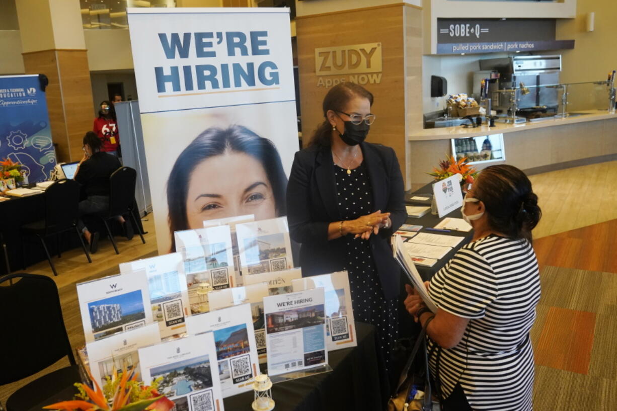 FILE - Marriott human resources recruiter Mariela Cuevas, left, talks to Lisbet Oliveros, during a job fair at Hard Rock Stadium, Friday, Sept. 3, 2021, in Miami Gardens, Fla.  Last month, U.S. employers might have shed jobs for the first time in about a year, potentially raising alarms about the economy's trajectory. Yet even if the January employment report coming Friday, Feb. 3, 2022, were to show a deep loss of jobs, there would be little mystery about the likely culprit: A wave of omicron wave of infections that led millions of workers to stay home sick, discouraged consumers from venturing out to spend and likely froze hiring at many companies -- even those that want to fill jobs.