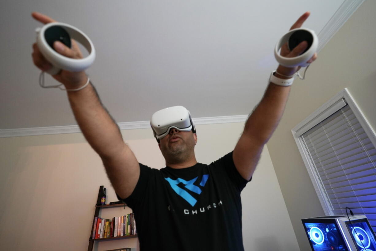 Pastor D.J. Soto, the lead pastor of VR Church, delivers a sermon in his home Jan. 23 in Fredericksburg, Va. Soto sings, preaches and performs digital baptisms in the metaverse to a growing congregation of avatars.