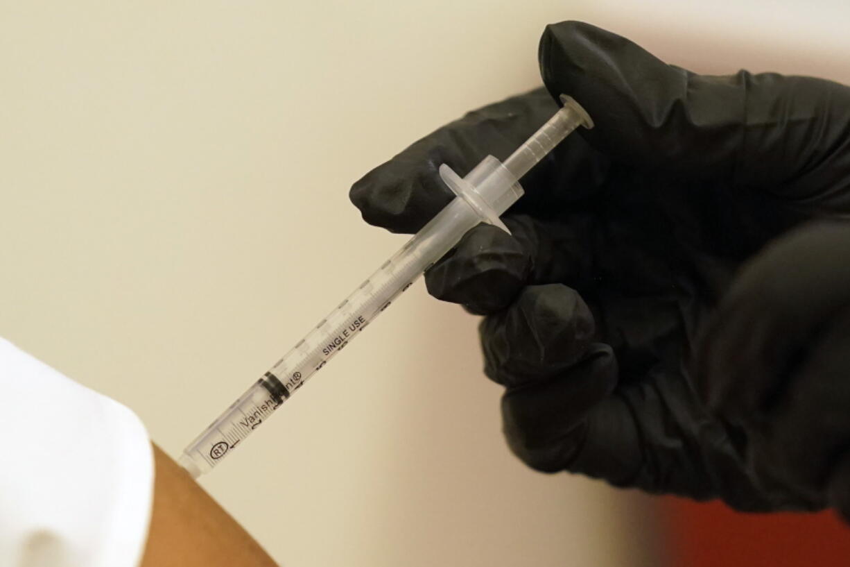 A person is injected with her second dose of the Pfizer COVID-19 vaccine at a Dallas County Health and Human Services vaccination site in Dallas, Thursday, Aug. 26, 2021.  Federal health regulators on Friday, Feb. 11, 2022 delayed next week's public meeting to review Pfizer's COVID-19 vaccine for children under 5, saying they want to see more data.