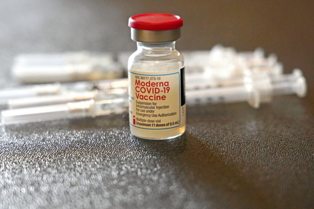 FILE - A vial filled with the Moderna COVID-19 vaccine rests by syringes waiting to be loaded by nurses from the Jackson-Hinds Comprehensive Health Center, at a vaccination station next to Jackson State University in Jackson, Miss., Tuesday, Dec. 7, 2021.  The vaccination drive against COVID-19 in the U.S. is grinding to a halt, and lagging demand is especially stark in conservative corners of the country where many people weren't interested in the shots in the first place. (AP Photo/Rogelio V.