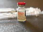 FILE - A vial filled with the Moderna COVID-19 vaccine rests by syringes waiting to be loaded by nurses from the Jackson-Hinds Comprehensive Health Center, at a vaccination station next to Jackson State University in Jackson, Miss., Tuesday, Dec. 7, 2021.  The vaccination drive against COVID-19 in the U.S. is grinding to a halt, and lagging demand is especially stark in conservative corners of the country where many people weren't interested in the shots in the first place. (AP Photo/Rogelio V.