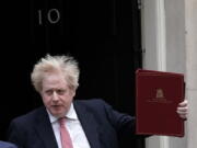 Britain's Prime Minister leaves 10 Downing Street, London, Monday Feb. 21, 2022, to head to the House of Commons.