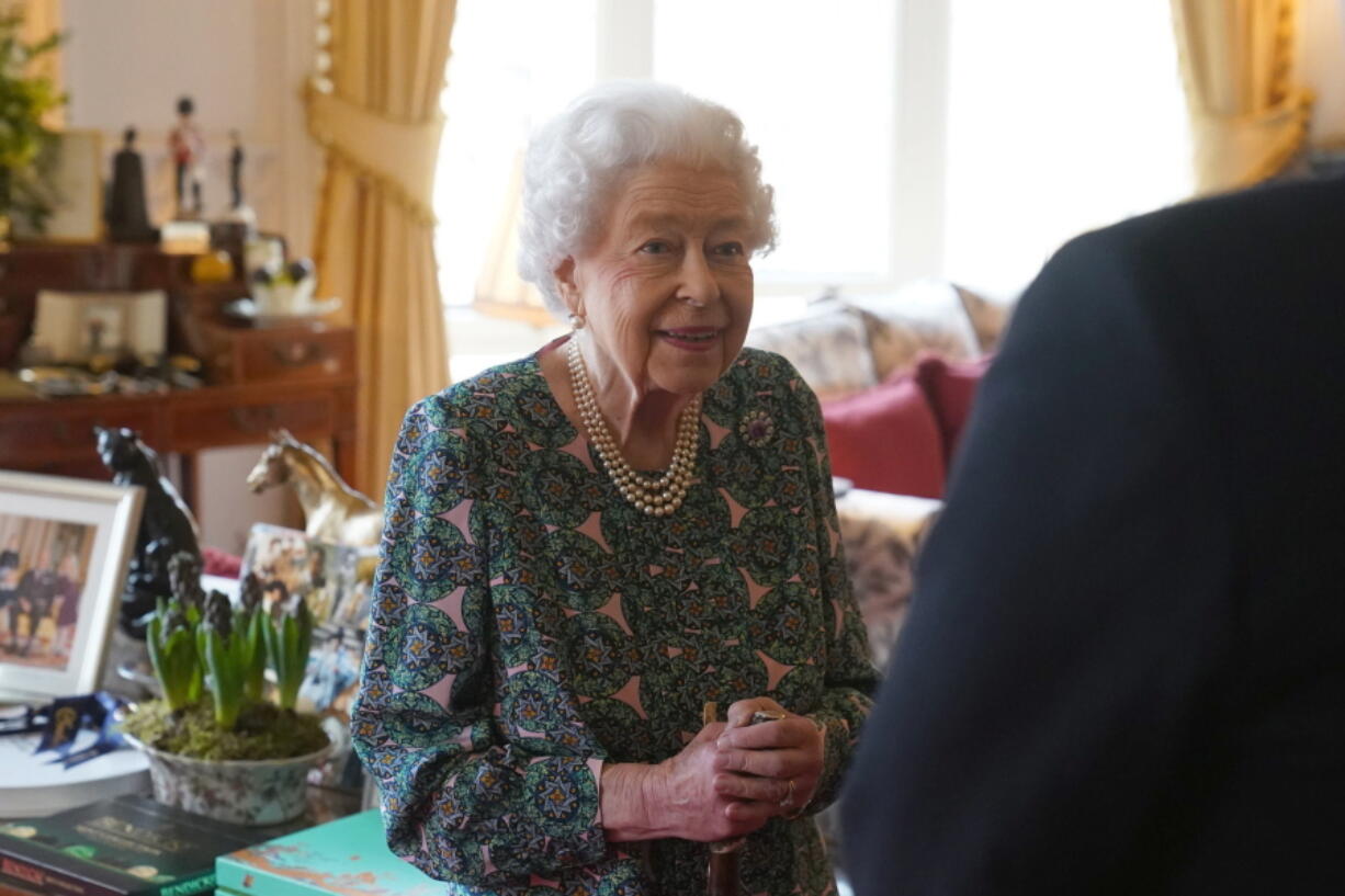 FILE - Queen Elizabeth II speaks during an audience at Windsor Castle where she met the incoming and outgoing Defence Service Secretaries, Wednesday Feb. 16, 2022. Buckingham Palace said Sunday, Feb. 20, 2022 that Queen Elizabeth II tested positive for COVID-19, has mild symptoms and will continue with duties.