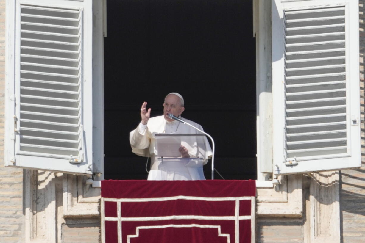 FILE - Pope Francis delivers the Angelus noon prayer from his studio window overlooking St. Peter's Square at the Vatican, Sunday, Feb. 6, 2022.