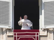 FILE - Pope Francis delivers the Angelus noon prayer from his studio window overlooking St. Peter's Square at the Vatican, Sunday, Feb. 6, 2022.