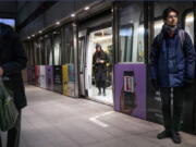 FILE - Passengers stand at the Noerreport Metrostation in Copenhagen Denmark, Tuesday, Feb. 1, 2022. Denmark has become one of the first European Union countries to scrap most pandemic restrictions as the country no longer considers the COVID-19 outbreak "a socially critical disease." Bit by bit, many countries that have been especially hard-hit by the coronavirus are easing their tough, and often unpopular, restrictive measures to fight COVID-19 even as the omicron variant -- deemed less severe -- has caused cases to skyrocket.