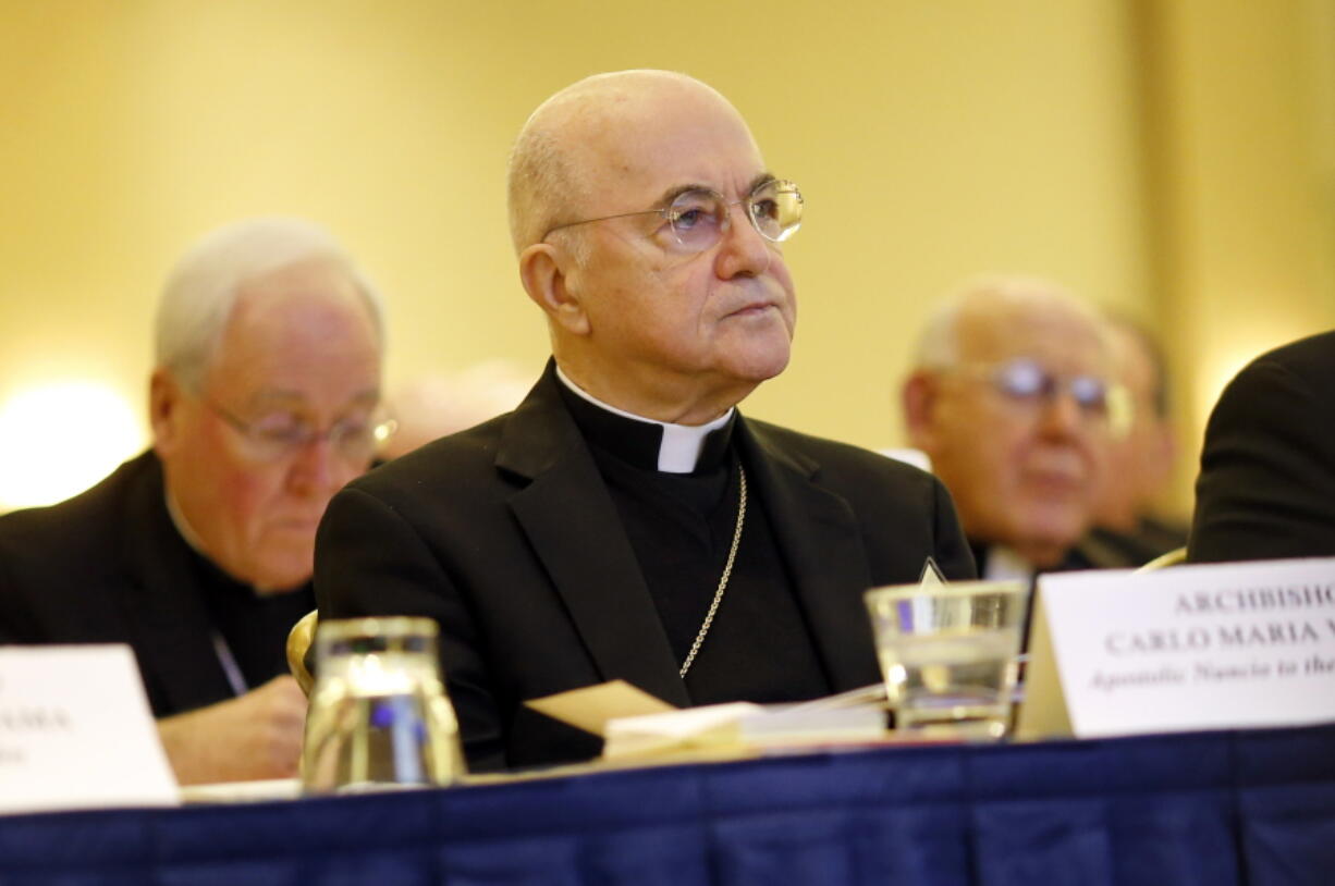 FILE - In this Nov. 16, 2015 file photo, Archbishop Carlo Maria Vigano, Apostolic Nuncio to the U.S., at the U.S. Conference of Catholic Bishops' annual fall meeting in Baltimore. Archbishop Santo Marcian? penned a letter to Italian law enforcement personnel in response to the latest missive from Archbishop Carlo Maria Vigano, the Vatican's onetime U.S. ambassador who went rogue in 2018 after calling for Pope Francis to resign over the clergy sexual abuse scandal. Vigano's anti-Francis missives have become increasingly unhinged, especially during the coronavirus pandemic which he has denied and termed a criminal pretext by a "globalist oligarchy" to enslave humanity.