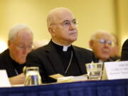 FILE - In this Nov. 16, 2015 file photo, Archbishop Carlo Maria Vigano, Apostolic Nuncio to the U.S., at the U.S. Conference of Catholic Bishops' annual fall meeting in Baltimore. Archbishop Santo Marcian? penned a letter to Italian law enforcement personnel in response to the latest missive from Archbishop Carlo Maria Vigano, the Vatican's onetime U.S. ambassador who went rogue in 2018 after calling for Pope Francis to resign over the clergy sexual abuse scandal. Vigano's anti-Francis missives have become increasingly unhinged, especially during the coronavirus pandemic which he has denied and termed a criminal pretext by a "globalist oligarchy" to enslave humanity.